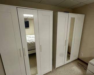A pair of white mirrored armoires! 