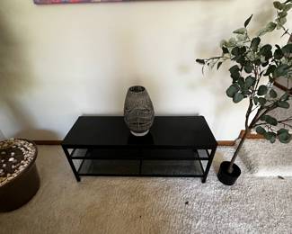 Interesting pastel colored art piece over a black side table! 