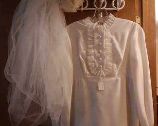 This wedding dress hangs on the door to the second bedroom, which is the doorway to the left, off of the living room.