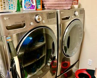 LG Stainless Steel Washer & Dryer Front Loaders on stands.