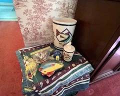 Bathroom decor, towels, soap dispenser, trash can