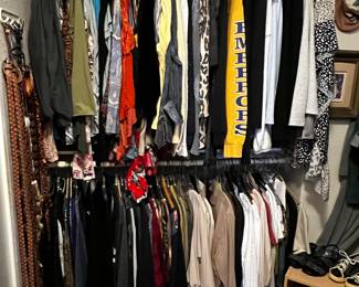 Walk in closet with lots of clothes 
