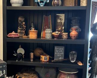 Computer shelf populated with items from traveling and a rare Fitz and Floyd Tiger cache pot 