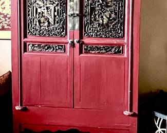 Red Chinese cabinet with carved and gilt panels 