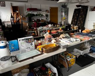 Garage is very clean and has cool things as well as a black leather sofa, carved wood Chinese armoire, refrigerator,  high top table with four chairs upholstered in animal print, and more!  