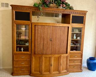 Large wood entertainment unit with rolling cabinet doors