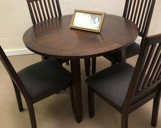 new 42" inch round table and 4 chairs with gray fabric seat