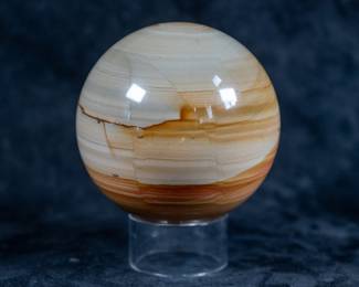 A sphere carved out of Serpentine. Comes on a clear plastic base.
