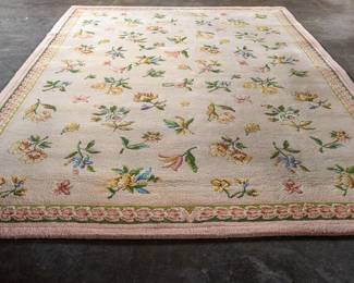 A large handwoven floral design wool area rug. In exceptional condition.
