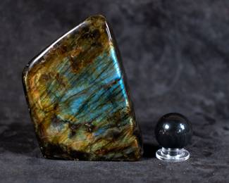 Two pieces of Labradorite: A small sphere and a larger stone with beautiful multi-colored reflection. Dimensions of largest piece included.
