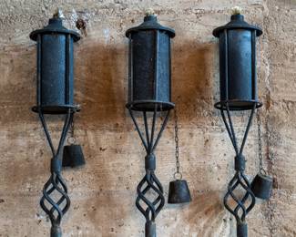 A set of three oil lawn torches in a beautiful wrought iron design. In good condition.
