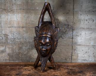 A wood carved mask originating from Gambia.
