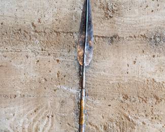 A Traditional African Hunting Spear, with a wide leaf spearhead and a iron cover on the butt of the spear. Brass decoration and rings on a hardwood spear shaft.
