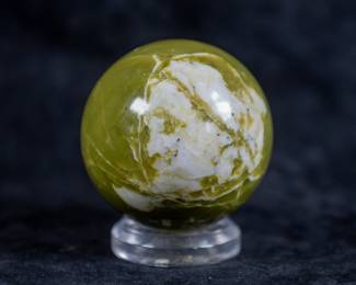 A sphere carved out of green Tremolite.
