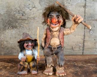 A pair of Norwegian Troll wood figurines. A large figurine holding a club, and a small troll fisherman. Largest figurine dimensions are included.
