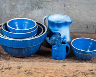 Large assortment of blue pottery. Six bowls made by Clay City Pottery. A small elephant shaped gravy pitcher. A large farmhouse design pitcher. Largest bowl dimensions are included.

