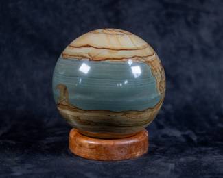A large Serpentine Sphere. Comes on a beautiful stained wood stand.
