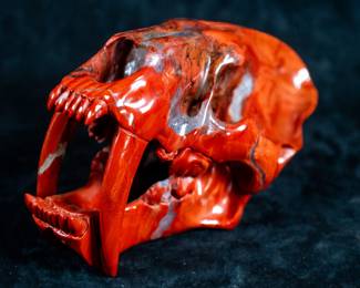 A Saber-Tooth Tiger skull carved out of Red Jasper.
