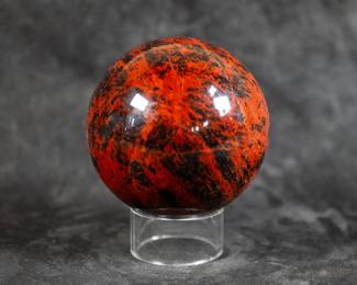 A sphere made out of Mahogany Obsidian. Comes on a clear plastic stand.
