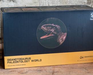 A Giganotosaurus Paleontology World Collectible Figure, made by Damtoys. In the original box.
