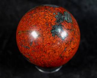A large sphere made of polished Polychrome Jasper. Comes with a clear plastic stand.
