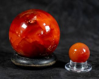 A pair of Carnelian spheres, one large and one small. The dimensions for the larger sphere are included.
