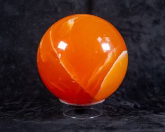 A large orange Calcite sphere, originating from Mexico. Comes on a clear plastic stand.
