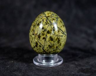 A carved Dendritic Agate Egg. Comes on a clear plastic base.
