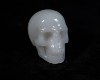 An Agate Skull in a padded box, made by Skullis.

