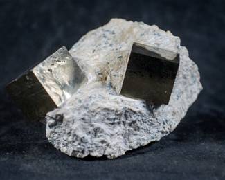 Two Iron Pyrite (Fools Gold) cubes in matrix.
