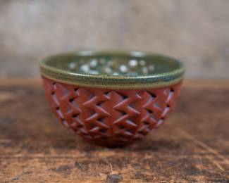 Studio pottery bowl by listed artist, Kenneth Standhardt. The art of Pre-Columbian Native Americans and the work of ancient cultures from around the world have been a strong influence on Kenneth's work. In particular, Kenneth is drawn to primitive vessels that were created by the process of pressing a layer of clay onto the interior surface of a basket.
