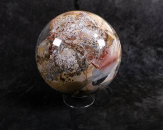A large Rhyolite Crystal Sphere. Originating from Australia. Comes with a clear plastic stand.
