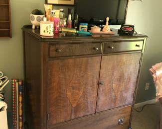 antique dresser, small flat screen tv, bathroom items