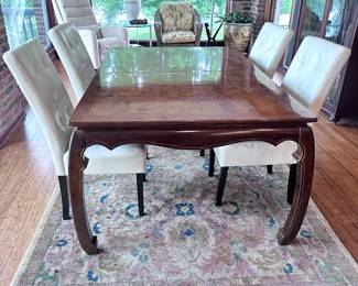 Universal table with 2 leaves and pads. Has 2 matching captain’s chairs.