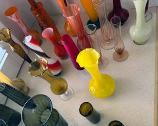 Many small glass vases, some hand-blown, in multiple styles + colors