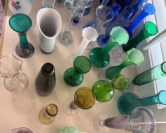 Many small glass vases, some hand-blown, in multiple styles + colors