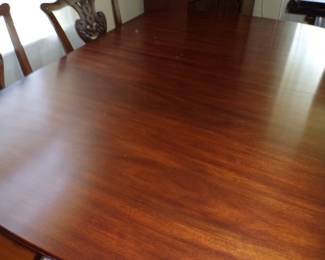 Henkel-Harris mahogany dining room table and extra leaves. Four side chairs and two captain chairs that are mahogany and upholstery. These are not Henkel-Harris but nonetheless very nice.