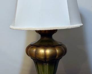 This Vintage Lamp features a stunning green and brass design and comes with its original shade, making it a unique addition to any space. Its overall condition is also well-preserved, ensuring a high-quality and long-lasting product.
