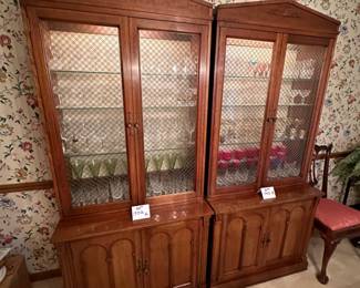 Pair of  Davis Cabinet Co. Solid Cherry cabinet with hutch. Hutch is lighted with glass shelves and brass double cross hatch on glass doors. We are selling separately (Waterford glassware has already been sold)