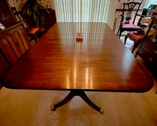 Kindel Winterthur Mahogany Dining table. 2 extension leaves, and table legs are on casters. Includes custom pads. Condition as shown.    68" x 46" plus 2- 12" leaves        