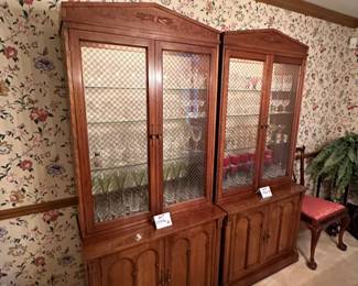 Pair of  Davis Cabinet Co. Solid Cherry cabinet with hutch. Hutch is lighted with glass shelves and brass double cross hatch on glass doors. We are selling separately (Waterford glassware has already been sold)