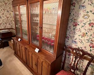 Pair of  Davis Cabinet Co. Solid Cherry cabinet with hutch. Hutch is lighted with glass shelves and brass double cross hatch on glass doors. We are selling separately (Waterford glassware has already been sold)