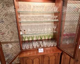 Pair of  Davis Cabinet Co. Solid Cherry cabinet with hutch. Hutch is lighted with glass shelves and brass double cross hatch on glass doors. We are selling separately (Waterford glassware has already been sold)