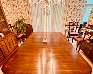Kindel Winterthur Mahogany Dining table. 2 extension leaves, and table legs are on casters. Includes custom pads. Condition as shown.    68" x 46" plus 2- 12" leaves        