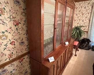 Pair of  Davis Cabinet Co. Solid Cherry cabinet with hutch. Hutch is lighted with glass shelves and brass double cross hatch on glass doors. We are selling separately (Waterford glassware has already been sold)