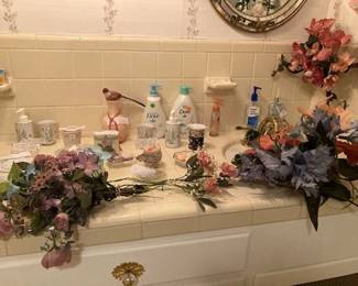 Toothbrush holders, or water cups, soap dispensers, or lotion dispensers, plus unopened, unused shampoo, conditioner, &/or body wash. a couple of vases, and Avon collectible container. Plus more flowers!