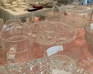 To left center of picture is 24% Lead Crystal D'Arques Long Champs Pitcher.  In center to right of pitcher is pedestal cake plate. In forefront is LE Smith Glass "Daisy and Button" Pattern Punch Bowl. Behind the pedestal cake plate & slightly to the right is another beautiful cake plate with Dome plain glass lid. 