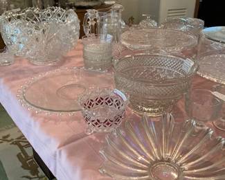 To left back corner is a LE Smith heavy cut crystal punch bowl, "Daisy and Button" pattern, with 18 cups and a glass ladle. in front of the punch bowl is a flat 14"platter with beaded edge and faint etched flowers & leaves on plate 