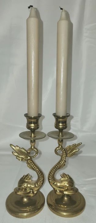 Pair of brass dolphin candle holders
