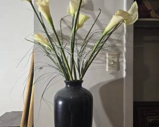 Black ceramic vase with faux flowers
